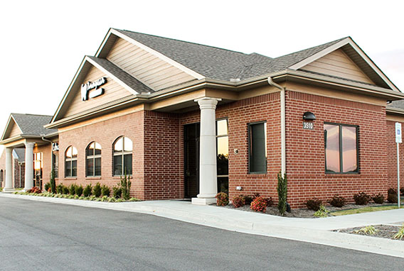 Modern brick dental office building with stone accents and professional landscaping.